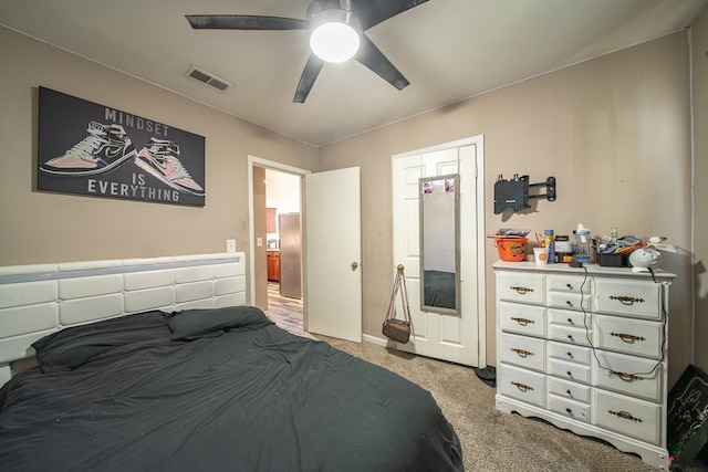 carpeted bedroom with visible vents and ceiling fan