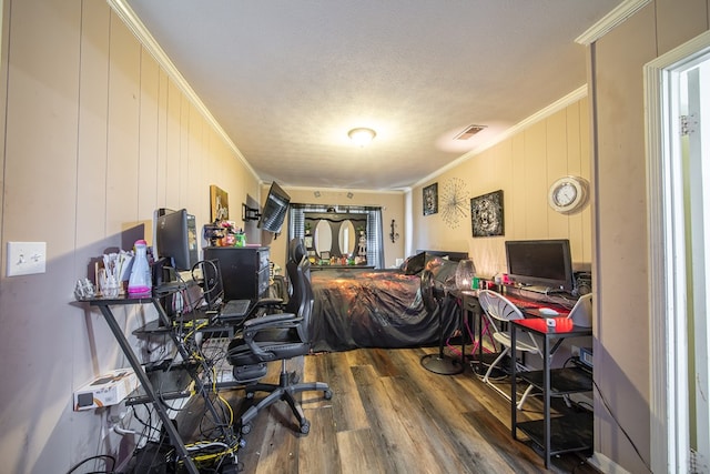 office featuring visible vents, crown molding, and wood finished floors