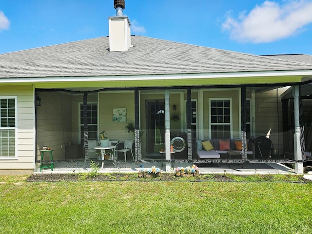 7 Hillside Ct, Phenix City, AL 36870 - back of house featuring roof with shingles, a yard, a patio area, and a chimney