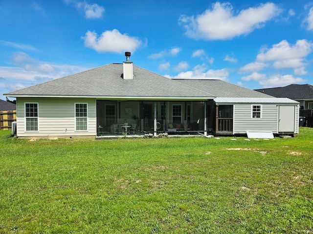 7 Hillside Ct, Phenix City, AL 36870 - back of property with a sunroom, a lawn, roof with shingles, a chimney, and a shed