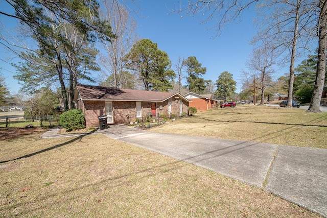 view of front of house with brick siding and a front lawn