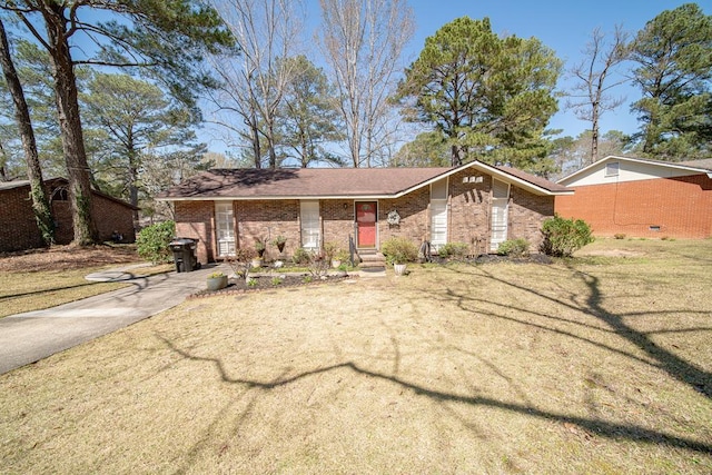 mid-century home featuring a front lawn and brick siding