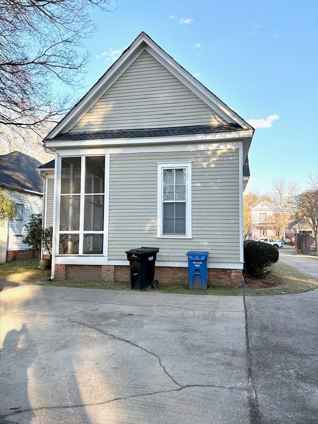 view of side of property featuring a sunroom