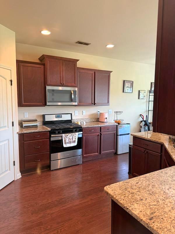 7613 Mockernut Way, Midland, GA 31820 - kitchen featuring stainless steel appliances, dark wood-type flooring, light stone countertops, and recessed lighting