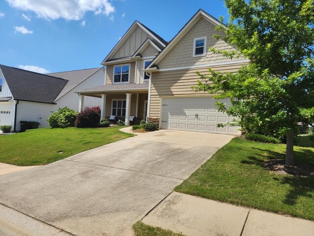 7613 Mockernut Way, Midland, GA 31820 - craftsman-style house featuring board and batten siding, a front yard, concrete driveway, stone siding, and a porch