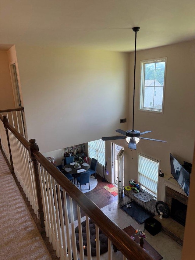 7613 Mockernut Way, Midland, GA 31820 - stairway featuring healthy amount of natural light, a stone fireplace, and ceiling fan