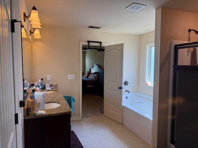 bathroom featuring ensuite bath, a garden tub, double vanity, and tile patterned floors