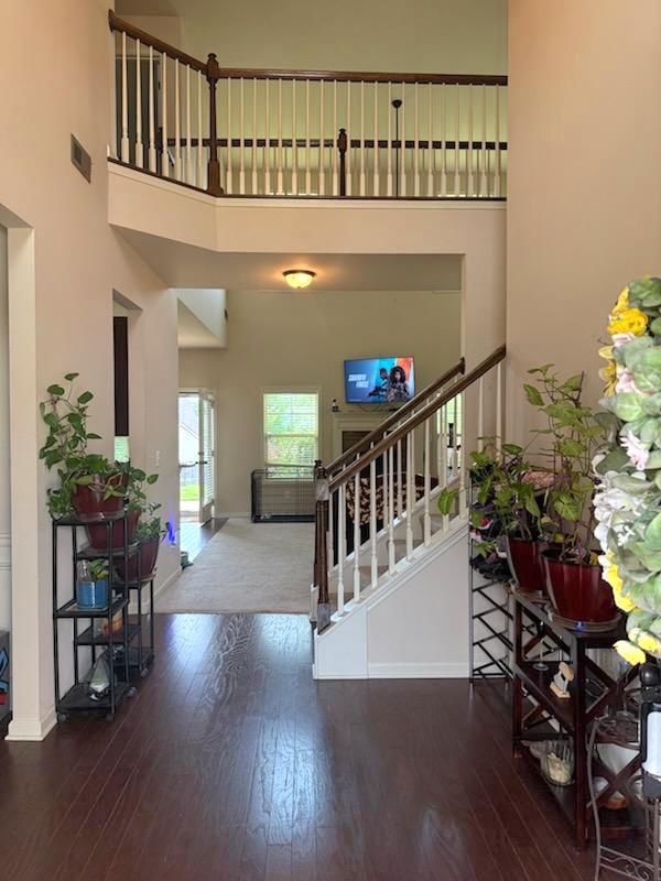7613 Mockernut Way, Midland, GA 31820 - entrance foyer with hardwood / wood-style flooring, stairs, baseboards, and a high ceiling