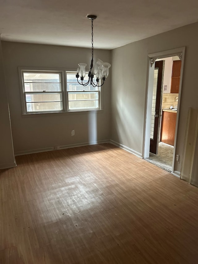 2908 Urban Ave, Columbus, GA 31907 - unfurnished dining area featuring wood finished floors, a chandelier, healthy amount of natural light, and baseboards