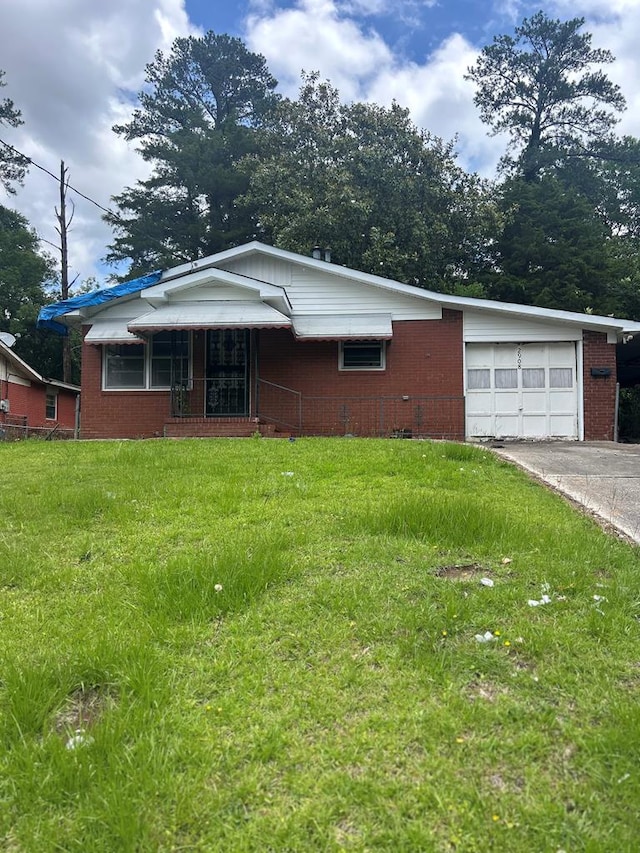 2908 Urban Ave, Columbus, GA 31907 - ranch-style home with a front yard, an attached garage, concrete driveway, and brick siding