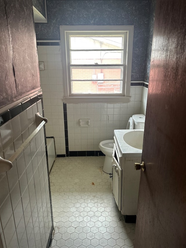 2908 Urban Ave, Columbus, GA 31907 - bathroom featuring tile walls, vanity, wainscoting, toilet, and wallpapered walls