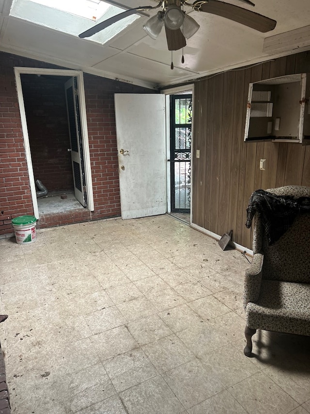 2908 Urban Ave, Columbus, GA 31907 - living area featuring a ceiling fan, lofted ceiling, brick wall, and wooden walls