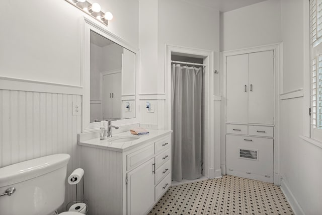 1809 Carter Ave, Columbus, GA 31906 - bathroom featuring wainscoting, tile patterned floors, vanity, a decorative wall, and a shower with curtain