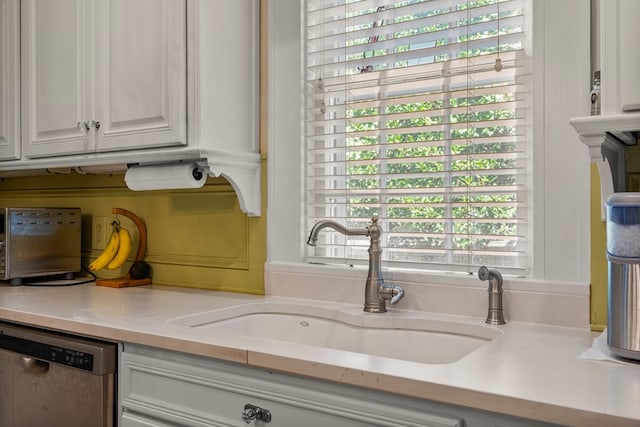1809 Carter Ave, Columbus, GA 31906 - kitchen with dishwasher, light countertops, and white cabinetry