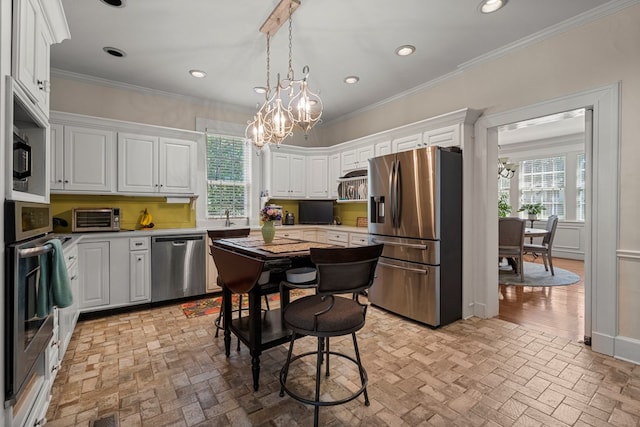 1809 Carter Ave, Columbus, GA 31906 - kitchen with a chandelier, appliances with stainless steel finishes, brick patterned floors, light countertops, and crown molding