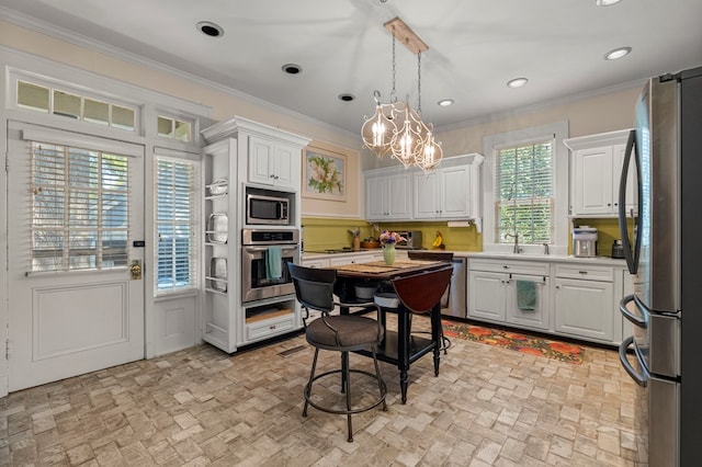 1809 Carter Ave, Columbus, GA 31906 - kitchen with stainless steel appliances, brick patterned flooring, crown molding, white cabinets, and light countertops