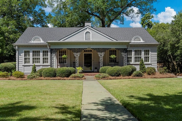 1809 Carter Ave, Columbus, GA 31906 - view of front of property with a front yard, a porch, a shingled roof, and a chimney