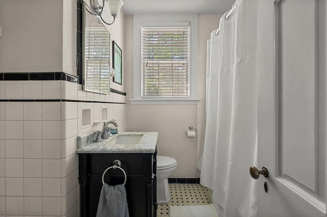 1809 Carter Ave, Columbus, GA 31906 - bathroom with vanity, curtained shower, and tile walls