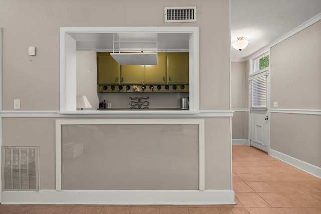 1809 Carter Ave, Columbus, GA 31906 - kitchen with green cabinets, light tile patterned floors, and light countertops