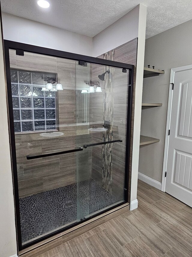 93 Pebble Ct, Smiths Station, AL 36877 - bathroom featuring a shower stall, a textured ceiling, and recessed lighting