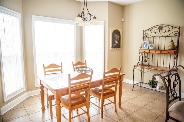 93 Pebble Ct, Smiths Station, AL 36877 - dining room featuring a chandelier, light tile patterned floors, and plenty of natural light