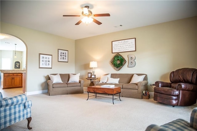 93 Pebble Ct, Smiths Station, AL 36877 - living area with light colored carpet, a ceiling fan, and arched walkways