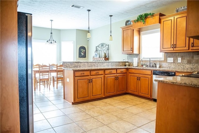 93 Pebble Ct, Smiths Station, AL 36877 - kitchen with dishwasher, brown cabinetry, a peninsula, pendant lighting, and a textured ceiling
