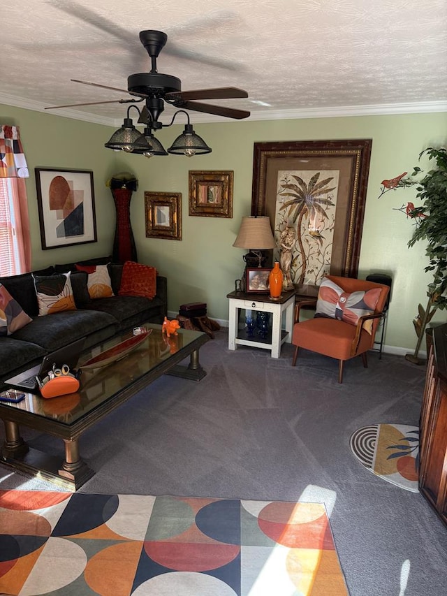 carpeted living room featuring a ceiling fan, baseboards, a textured ceiling, and ornamental molding