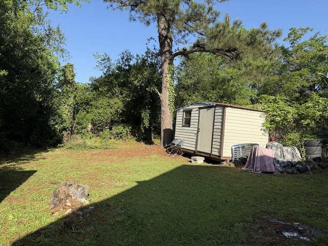 view of yard with an outdoor structure and a shed