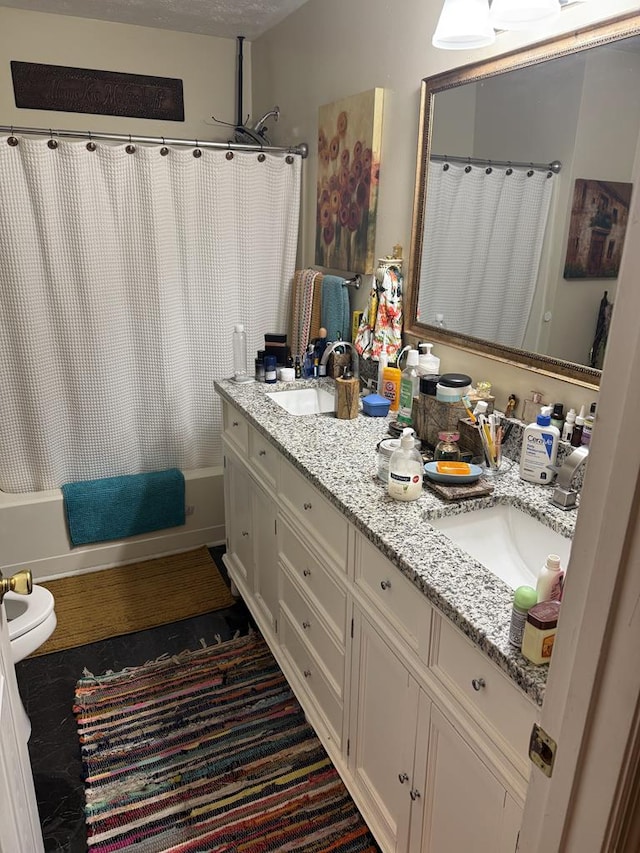 bathroom featuring shower / bath combo, a sink, and double vanity