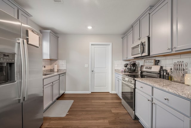 6368 Sandy Bottom Dr, Columbus, GA 31907 - kitchen with stainless steel appliances, gray cabinets, decorative backsplash, dark wood-type flooring, and light stone counters