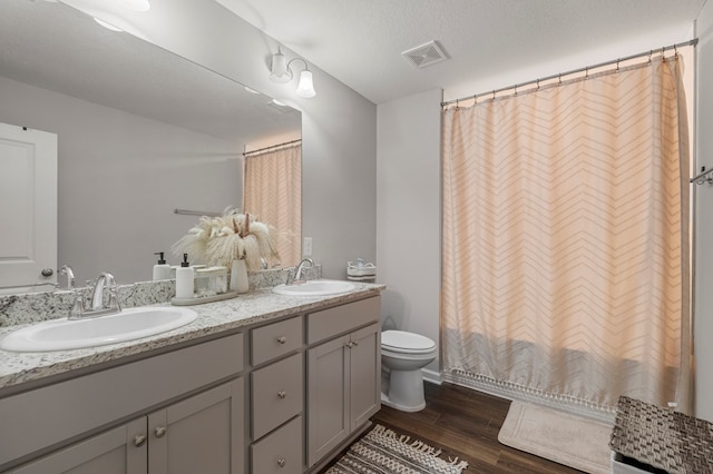 6368 Sandy Bottom Dr, Columbus, GA 31907 - full bath featuring wood finished floors, double vanity, and curtained shower