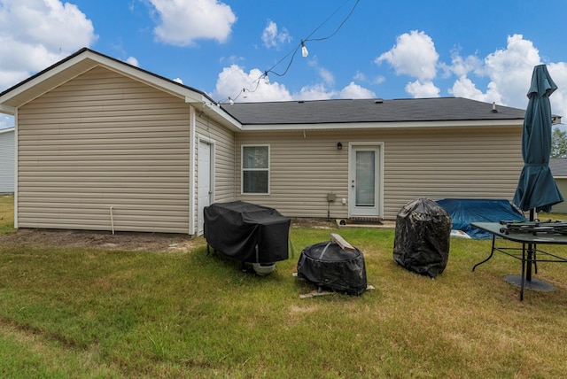 6368 Sandy Bottom Dr, Columbus, GA 31907 - rear view of property featuring a fire pit, a yard, and a garage