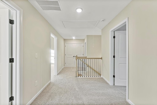 hallway with light colored carpet