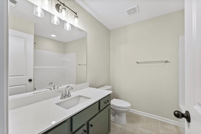 bathroom with tile patterned floors, vanity, toilet, and walk in shower