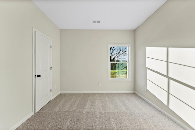 unfurnished room featuring light colored carpet