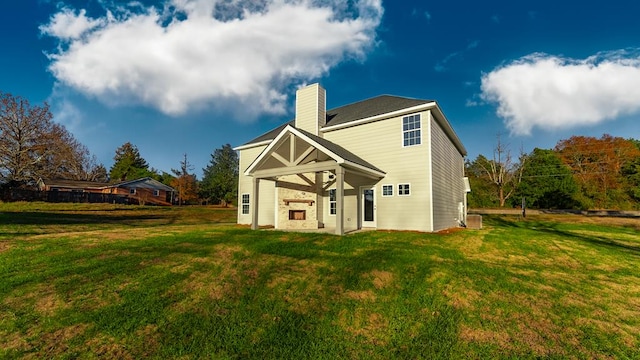 back of house with a lawn