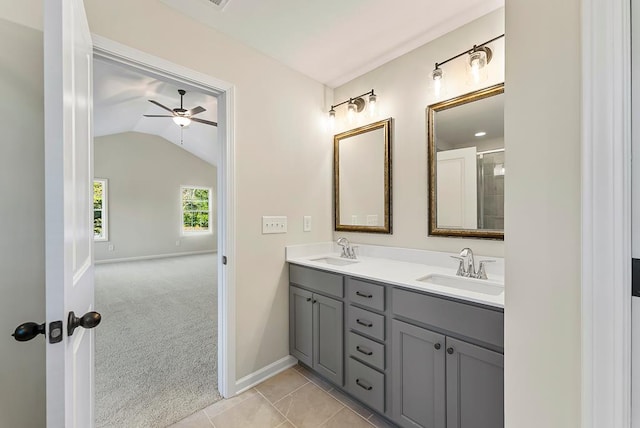 bathroom featuring tile patterned flooring, ceiling fan, lofted ceiling, and vanity