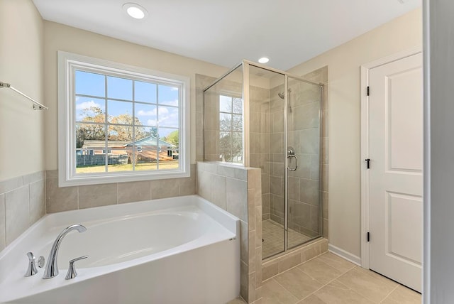 bathroom featuring tile patterned flooring and separate shower and tub