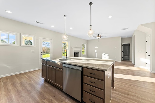 kitchen with pendant lighting, dishwasher, sink, light hardwood / wood-style flooring, and ceiling fan