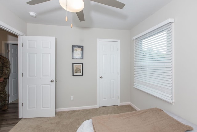 carpeted bedroom with ceiling fan