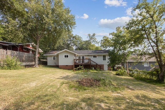 back of house with a deck and a yard