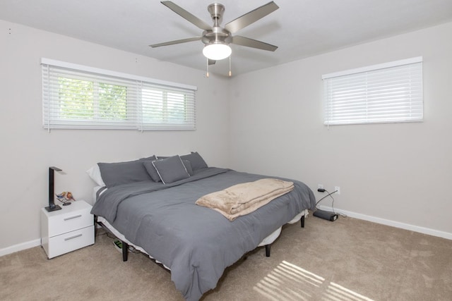 bedroom featuring light carpet and ceiling fan