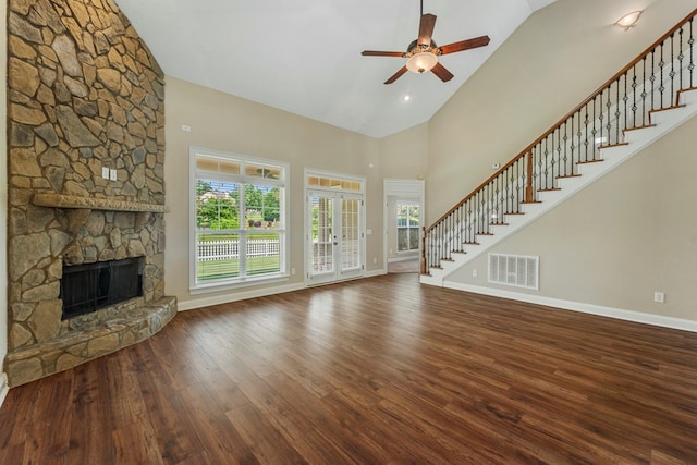 1032 Red Maple Way, Columbus, GA 31904 - unfurnished living room featuring stairway, high vaulted ceiling, a ceiling fan, a stone fireplace, and wood finished floors