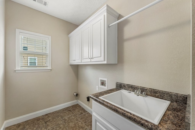 1032 Red Maple Way, Columbus, GA 31904 - washroom with hookup for a washing machine, baseboards, cabinet space, and dark tile patterned flooring
