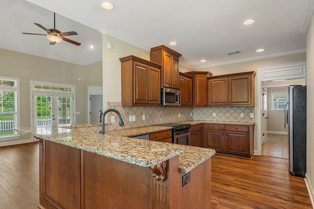 1032 Red Maple Way, Columbus, GA 31904 - kitchen with appliances with stainless steel finishes, a peninsula, ceiling fan, plenty of natural light, and recessed lighting