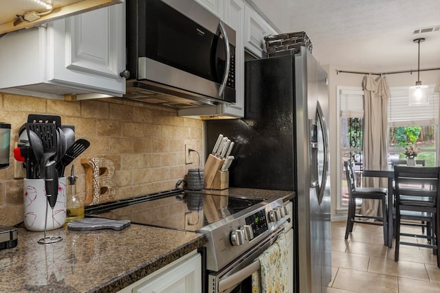 5936 Manassas Dr, Columbus, GA 31909 - kitchen featuring stainless steel appliances, tasteful backsplash, white cabinets, light tile patterned floors, and hanging light fixtures