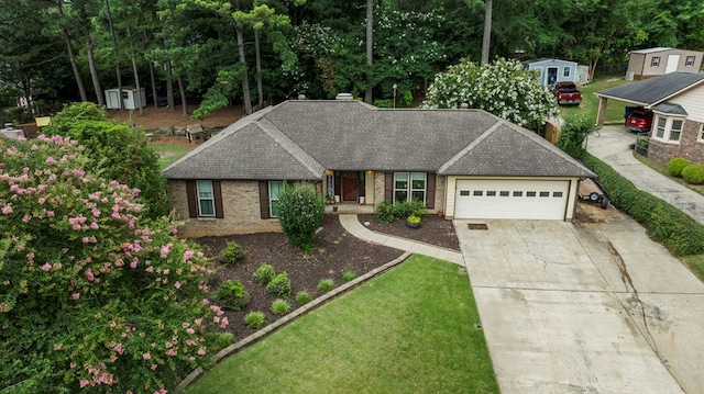 5936 Manassas Dr, Columbus, GA 31909 - single story home with a shed, an attached garage, driveway, brick siding, and a front yard