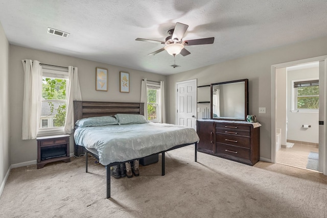 5936 Manassas Dr, Columbus, GA 31909 - bedroom featuring light carpet, multiple windows, a closet, connected bathroom, and a textured ceiling