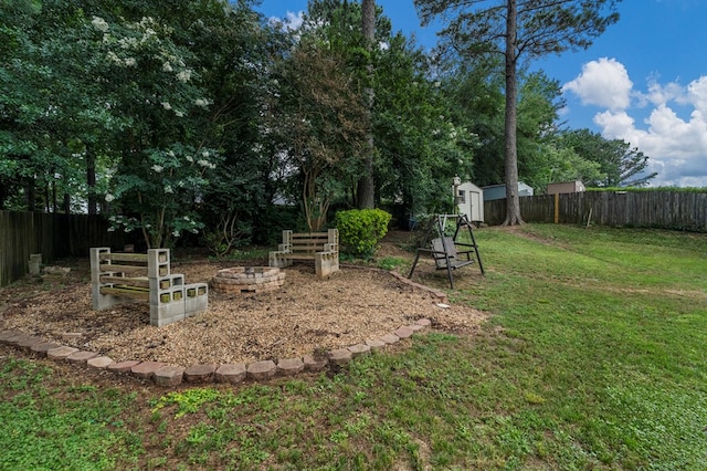 5936 Manassas Dr, Columbus, GA 31909 - fenced backyard featuring a storage unit and a fire pit